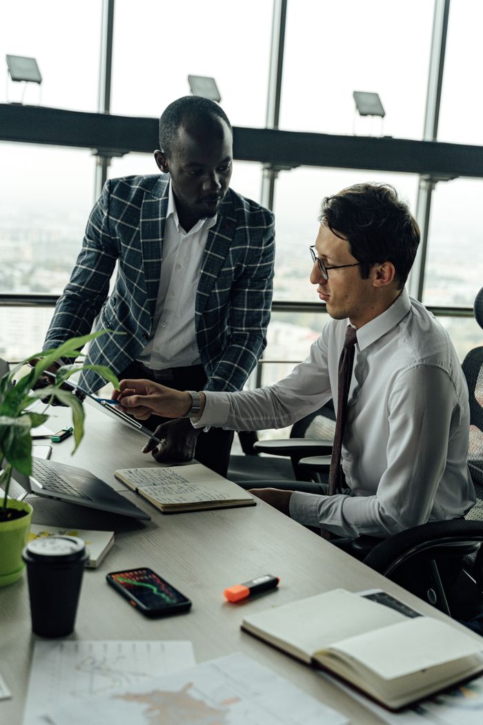 Crafting Captivating Headlines: Your awesome post title goes here Two businessmen discussing projects in a modern high-rise office setting.